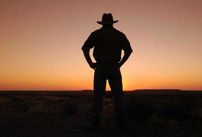 Outback adventures outback adventures at dusk with cowboy wearing a hat