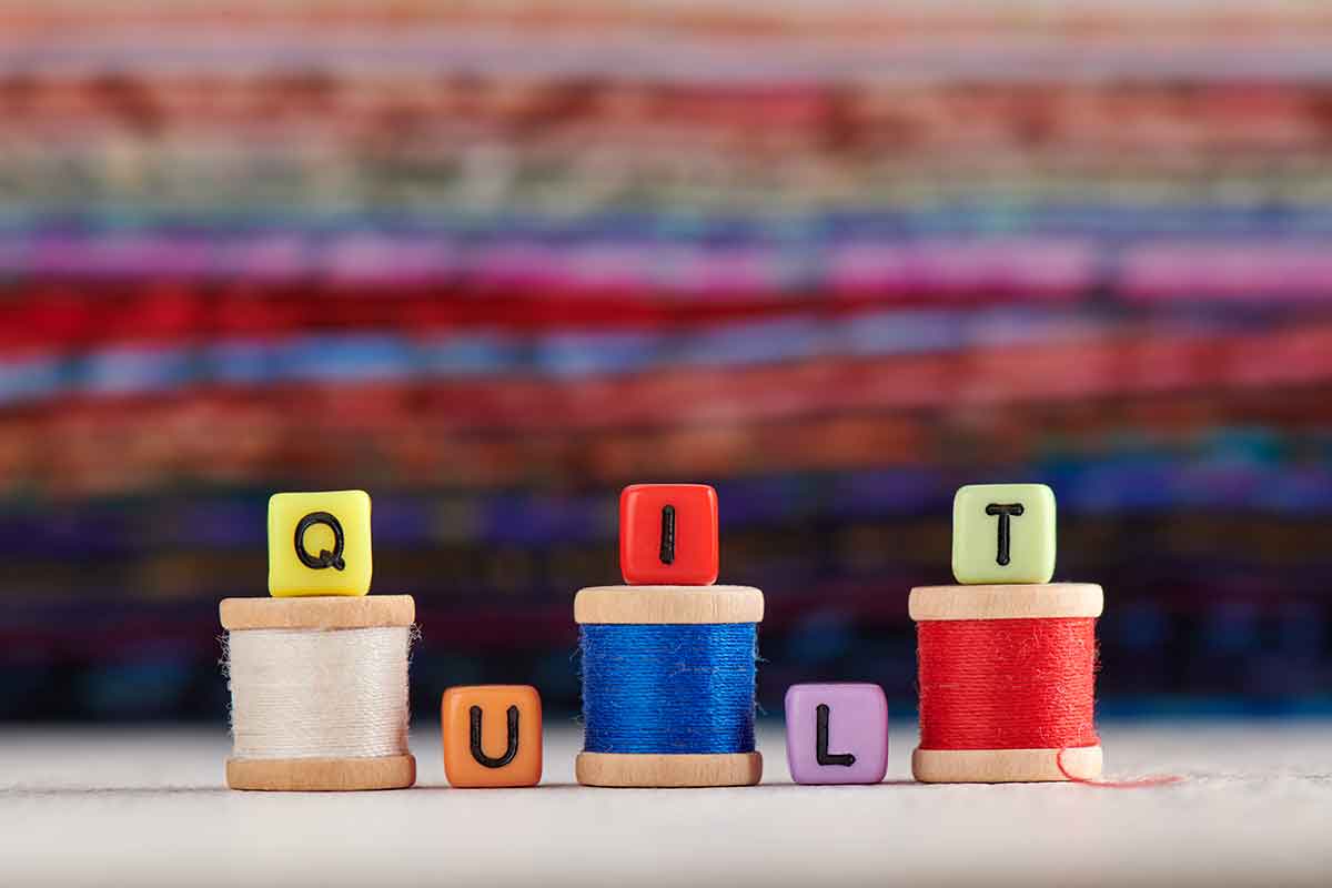 three spools of thread with letters Quilt