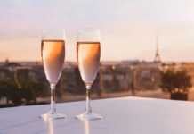 paris at night eiffel tower two glasses of champagne