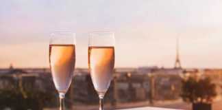 paris at night eiffel tower two glasses of champagne
