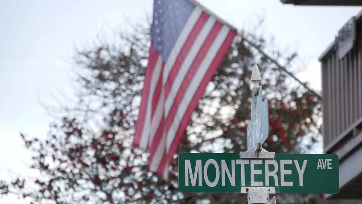 street sign that says Monterey Ave and US flag