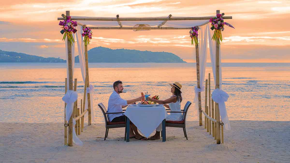 couple dining on a beach in phuket