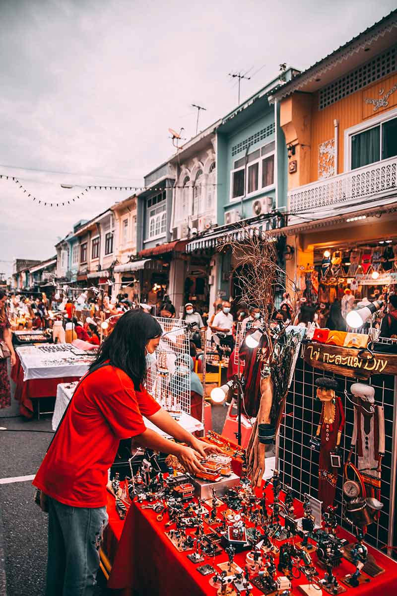 vendor arranging her wares in phuket old town night market