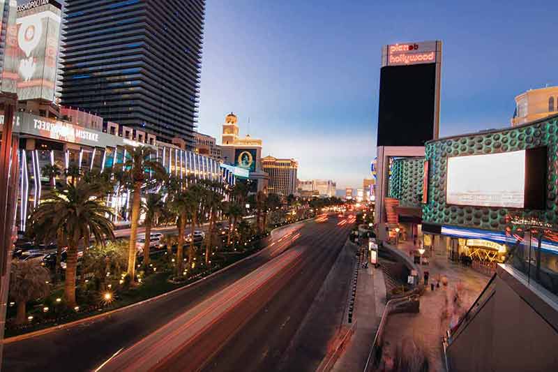 pictures of cities at night Cityscape showing a road and city lights in The Strip in Las Vegas.