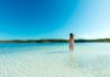 woman standing in Lake Mackenzie, one of the amazing places to visit in queensland