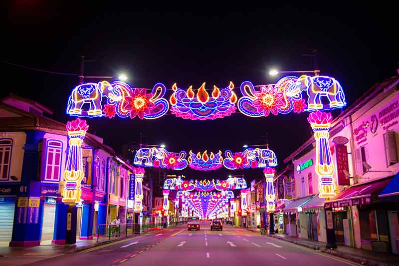 places to visit in singapore at night neon banners in Little India