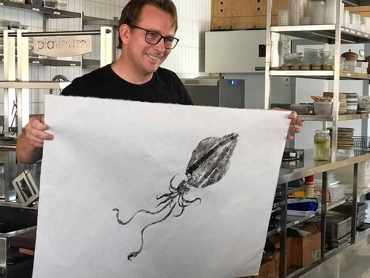 Ben Devlin showing off a piece of squid art
