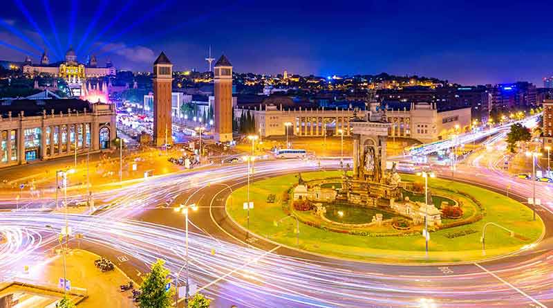 private day trips from madrid night view of Barcelona from the trade center Arenas de Barcelona. The central square (Plaça d'Espanya) with numerous traffic light trails and historical architecture, Spain