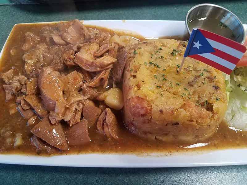 puerto rico weather best time to visit flag on plate of plantain and meat