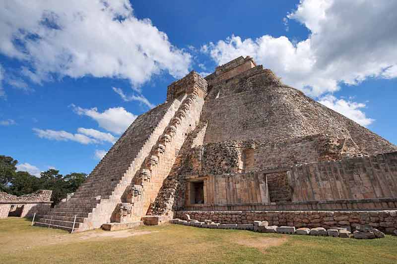 pyramid in uxmal mayan ruins against blue sky