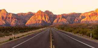 golden light just after dawn on the canyon and a road leading to it