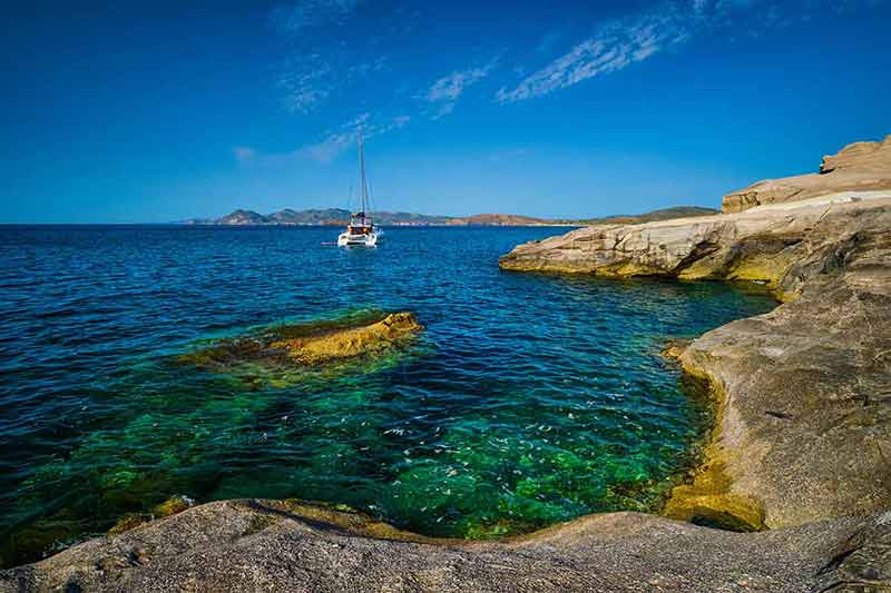 santorini greece best time to visit yacht near rocks