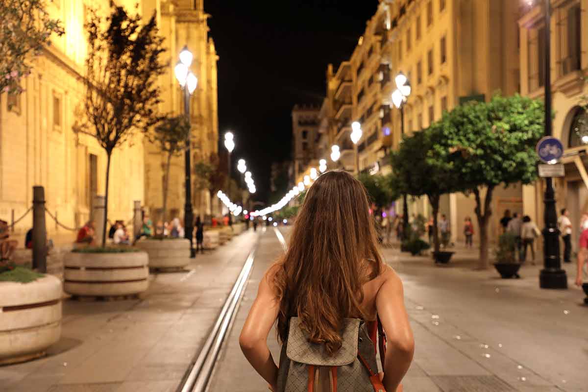seville at night girl walking down a street