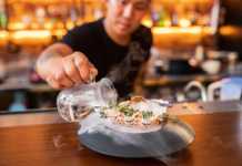 20 Bars in Singapore You’ll Want to Drink Your Way Through at Least Once singapore bars Hopscotch bartender pouring liquid into a cocktail served in a shell