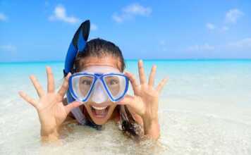 girl wearing blue mask and snorkel in the water