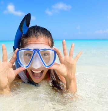 girl wearing blue mask and snorkel in the water