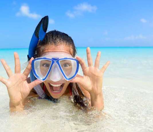 girl wearing blue mask and snorkel in the water