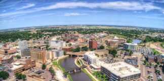20 South Dakota Cities And Towns Beyond Mount Rushmore aerial view of sioux falls city and river