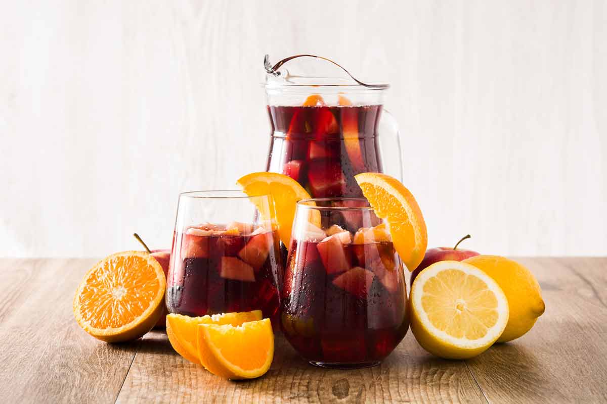 spanish alcoholic drinks sangria in glass tumbler on wooden table.