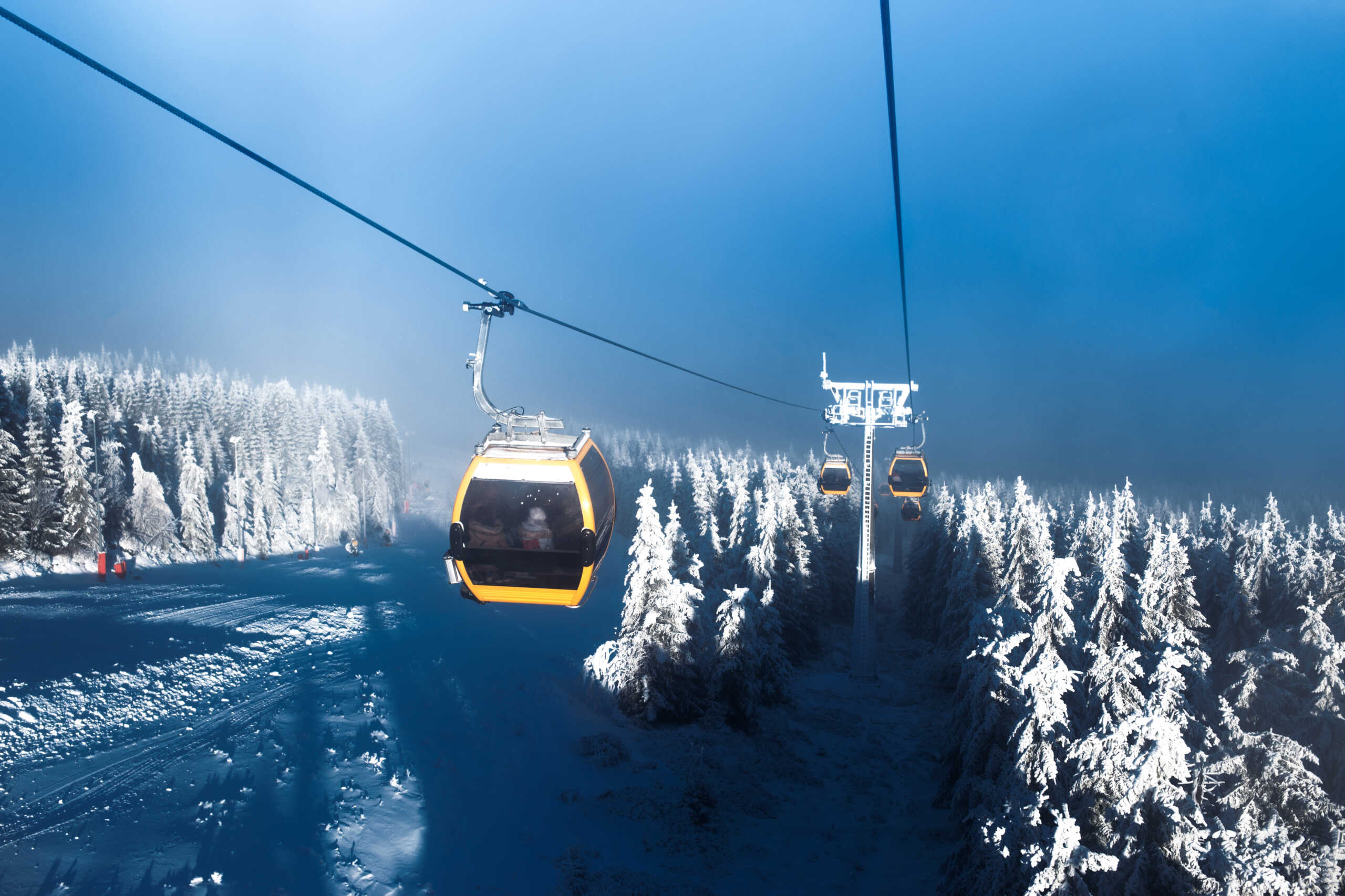 Gondolas rises in the mountains, ski resort, snow covered Christmas trees, winter landscape