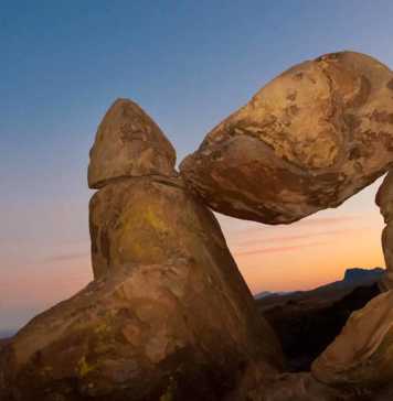 texas national parks map rock balanced precariously between two other boulders at dusk