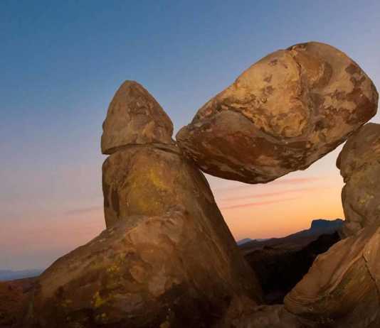 texas national parks map rock balanced precariously between two other boulders at dusk