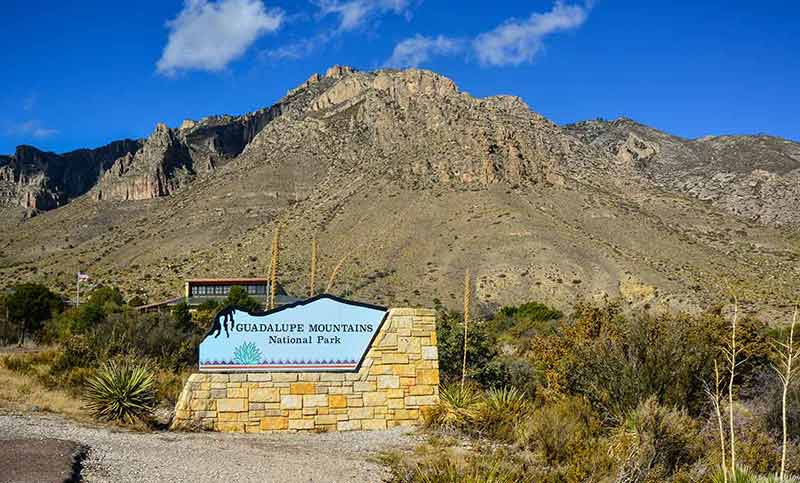 texas national parks information sign and rockface behind it