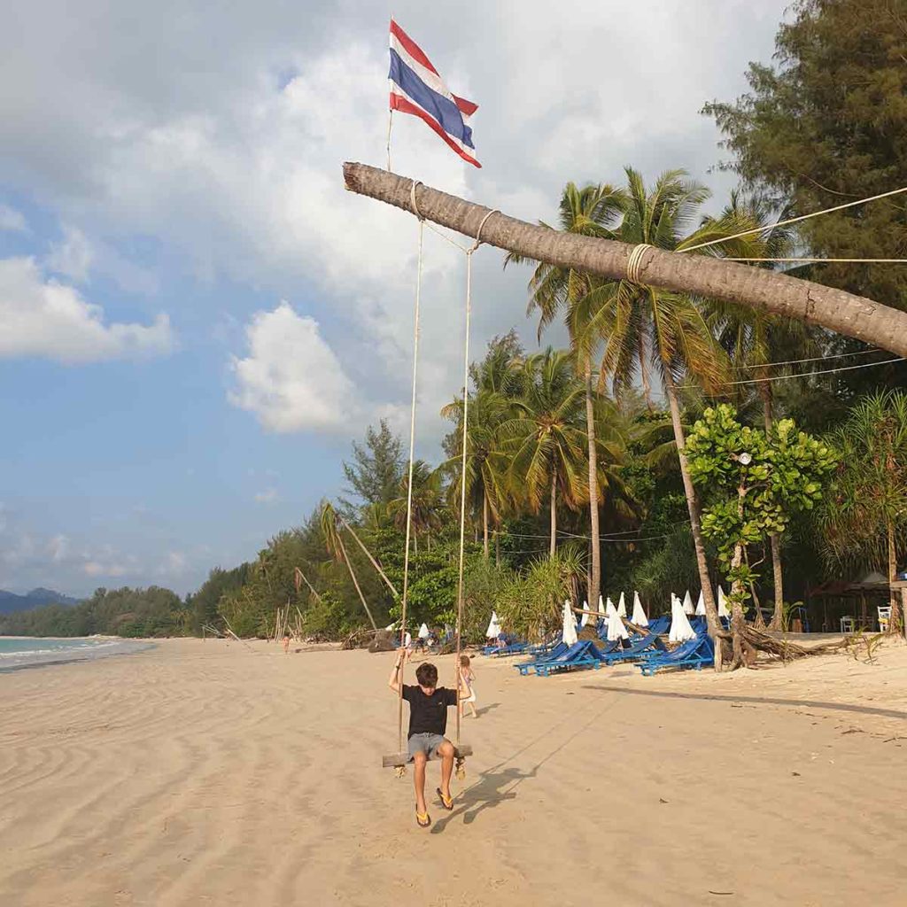 Boy on Khao Lak beach swing in Thailand