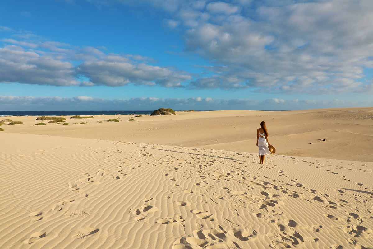 the longest beach in the world woman standing on Corralejo Dunas beach