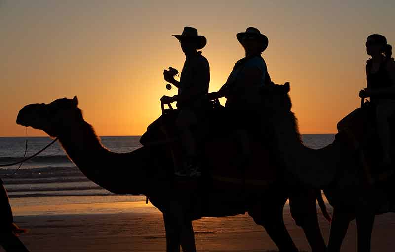 things to do at broome - two men on a camel at sunset
