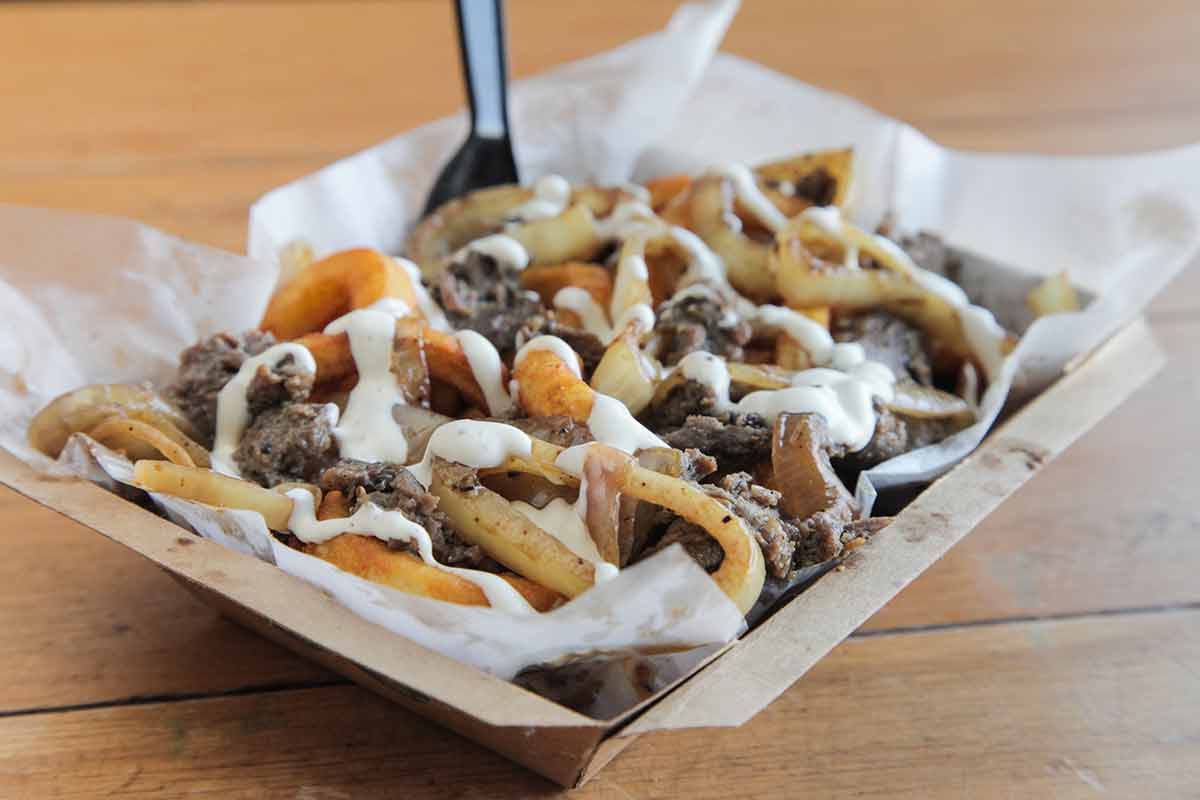 Poutine Curly Fries With Beef Meat Topped With Cheese And Mayo
