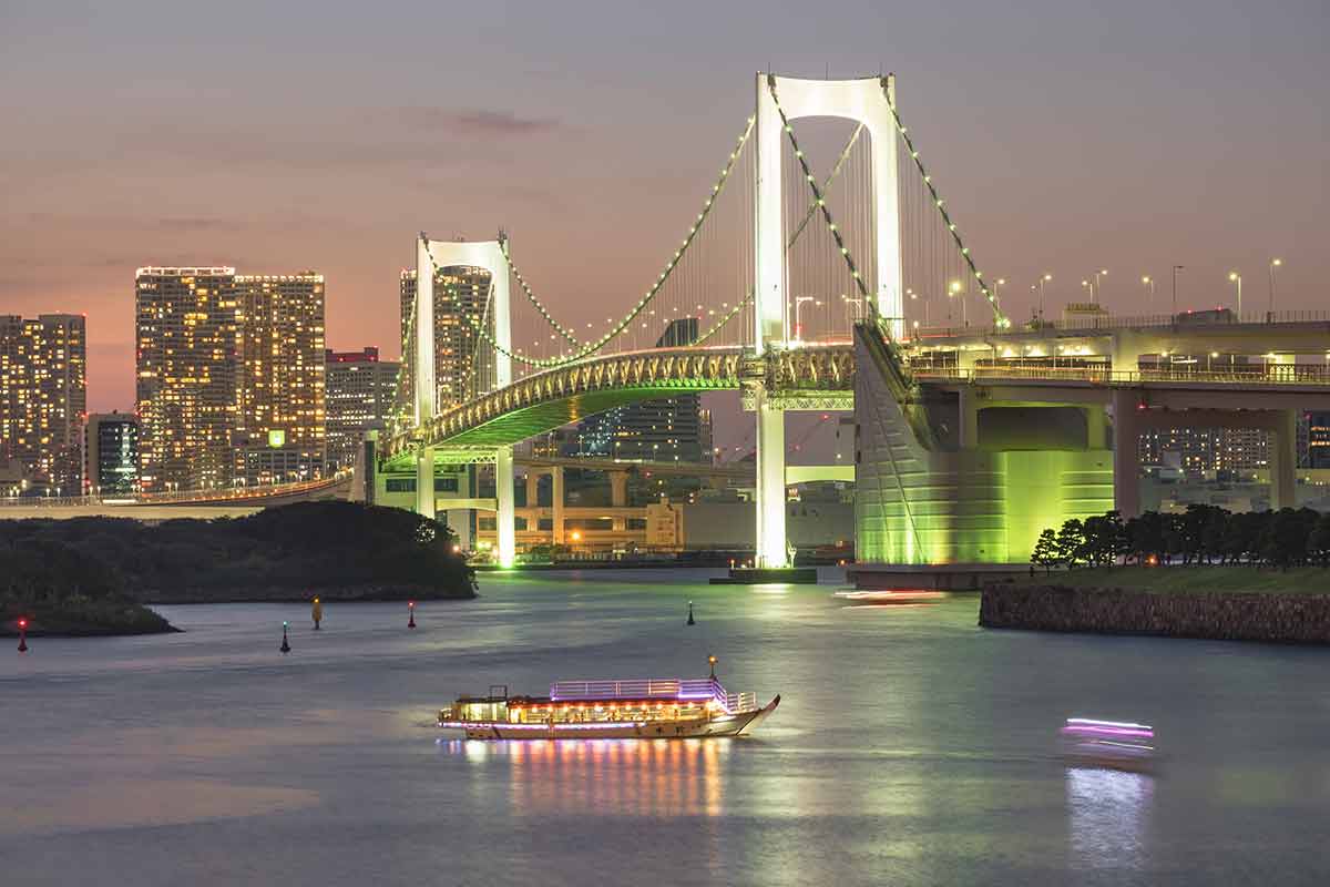 Rainbow bridge and barge in Tokyo at night