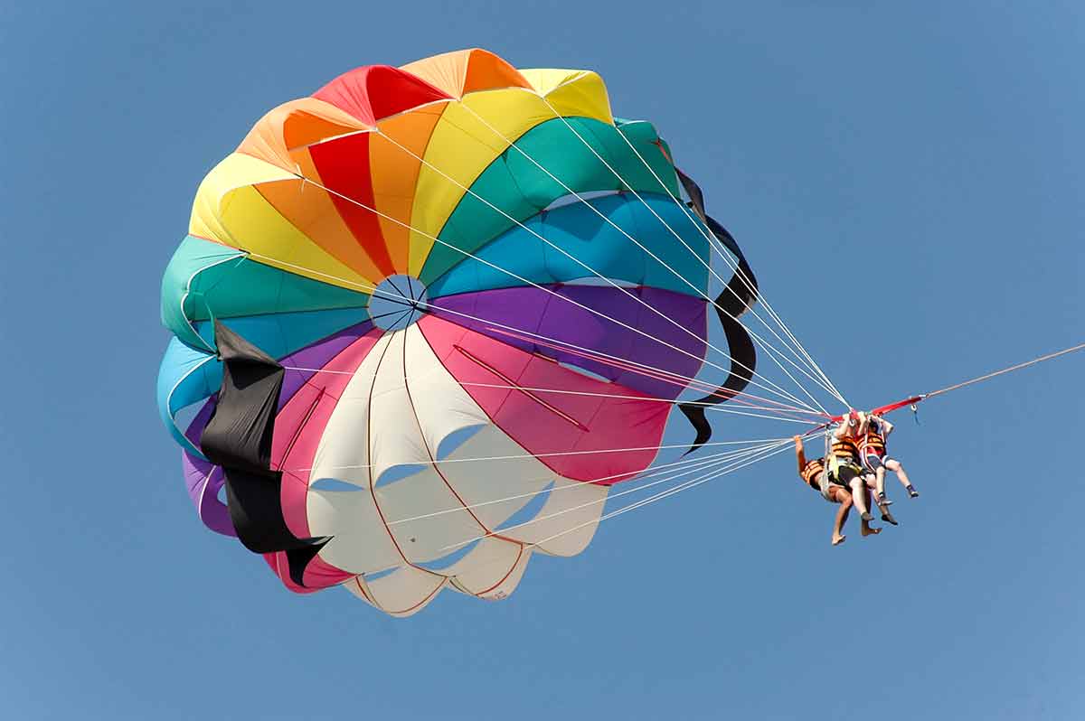 tandem parasailing with three people
