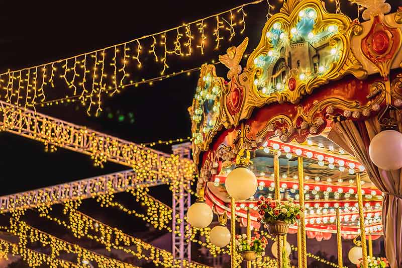 Illuminated Swing Chain Carousel In Amusement Park