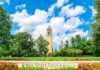 20 things to do in Ames that are better than you think Iowa State University tower, blue sky and green lawns with sign