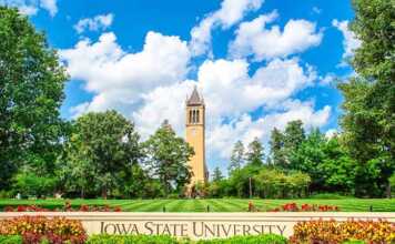 20 things to do in Ames that are better than you think Iowa State University tower, blue sky and green lawns with sign