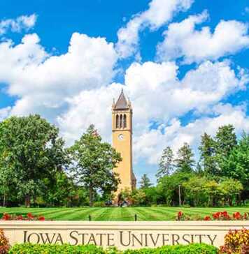 20 things to do in Ames that are better than you think Iowa State University tower, blue sky and green lawns with sign