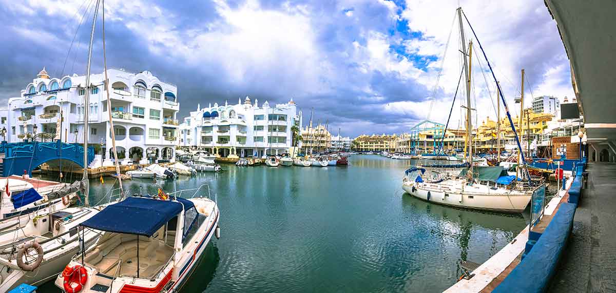 boats at benalmadena port and white-washed buildings