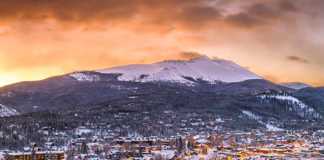 things to do in breckenridge colorado city at dusk with mountain in the background in winter