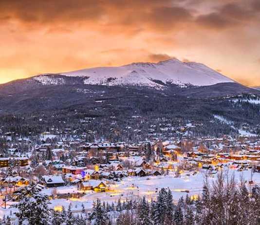 things to do in breckenridge colorado city at dusk with mountain in the background in winter
