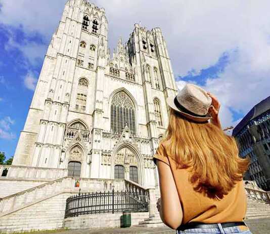 Back View Of Tourist Girl Visiting Brussels Cathedral, Belgium, Europe.
