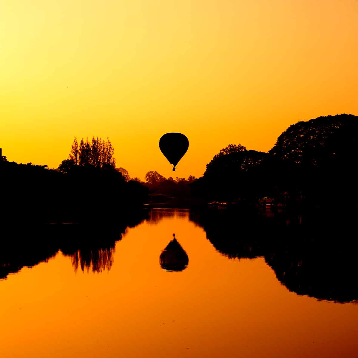 Hot Air Balloon At Sunrise On The River