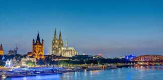 Skyline Of Cologne at night with cathedrals lit up