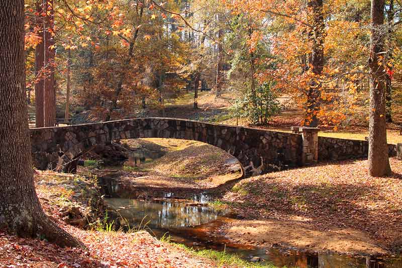 stone bridge at Flat Rock Park in the fall in columbus georgia