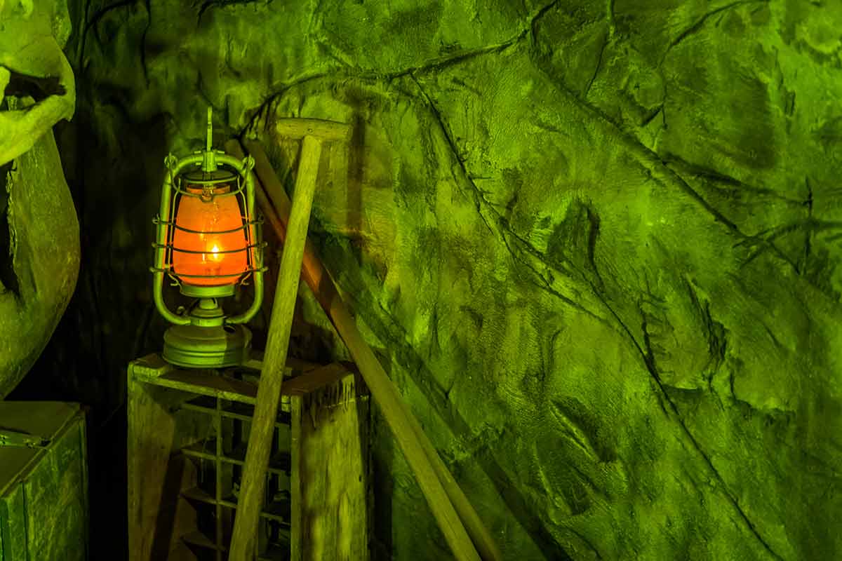 things to do in deadwood sd in December Old miner background with a lighted lantern and shovel, underground in a gold mine.