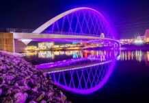 Des Moines, Iowa, skyline and bridge illuminated at night
