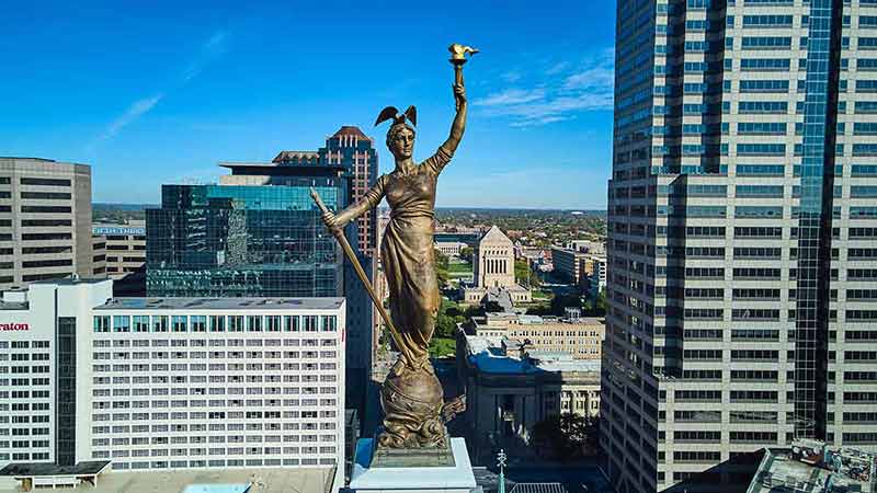 Image of Soldiers and Sailors Monument statue at the top with downtown background