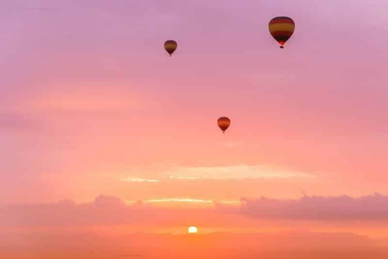 Balloons floating in a pink sky in Dubai