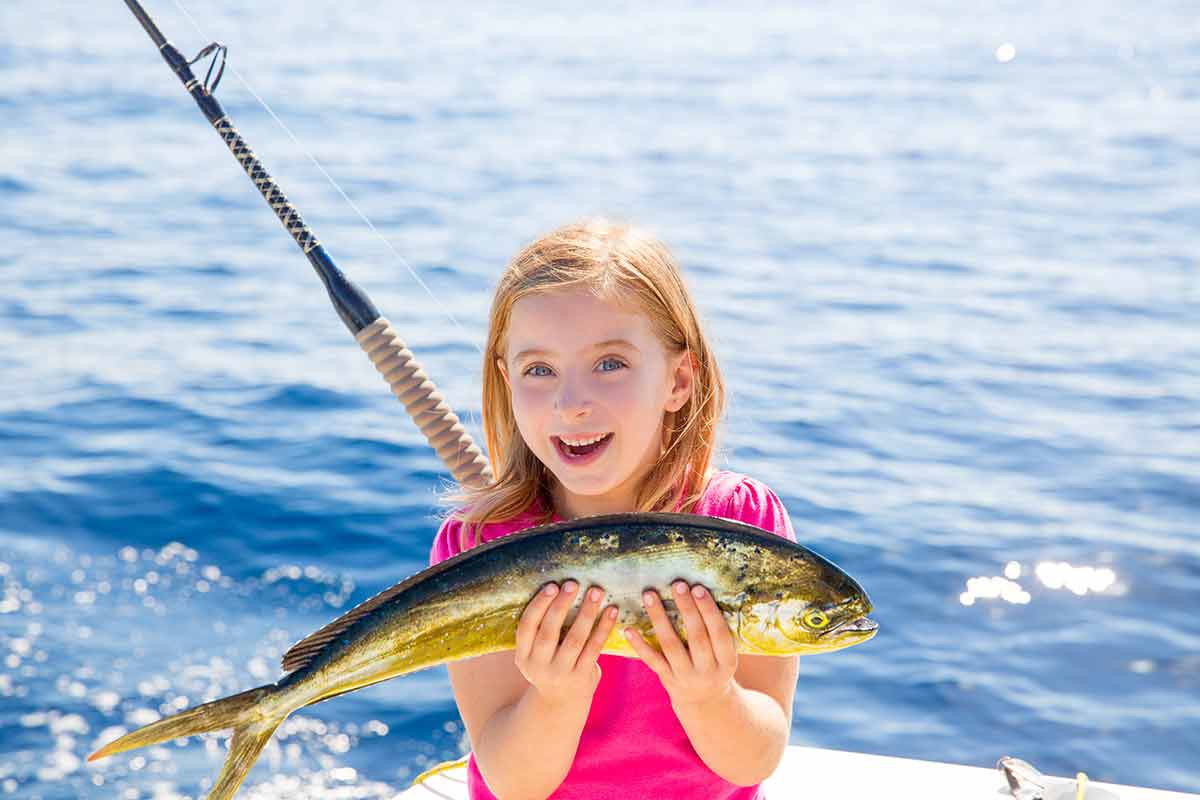 things to do in ensenada with family blond girl holding a dorado