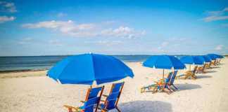 things to do in fort myers with kids blue chaise lounges and umbrellas on the beach